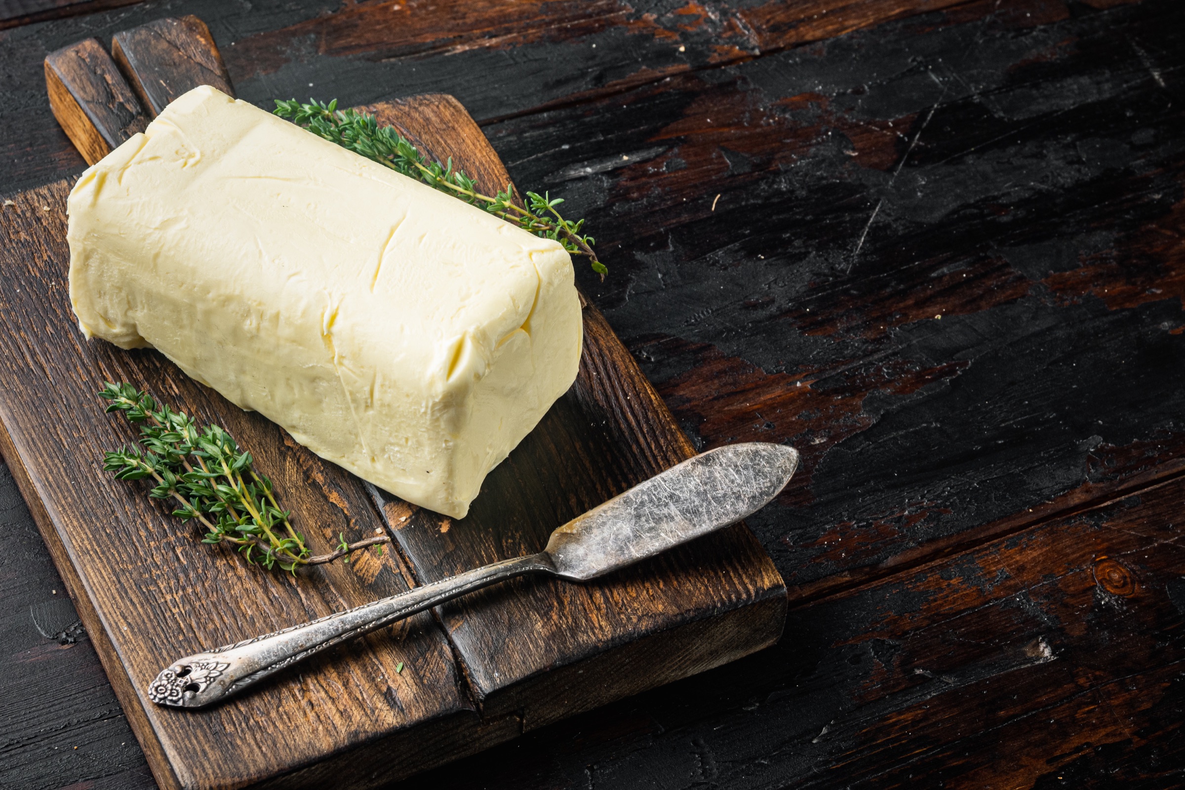 Fermented cream with herbs on a wooden board